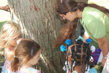 early childhood students with educator studying tree